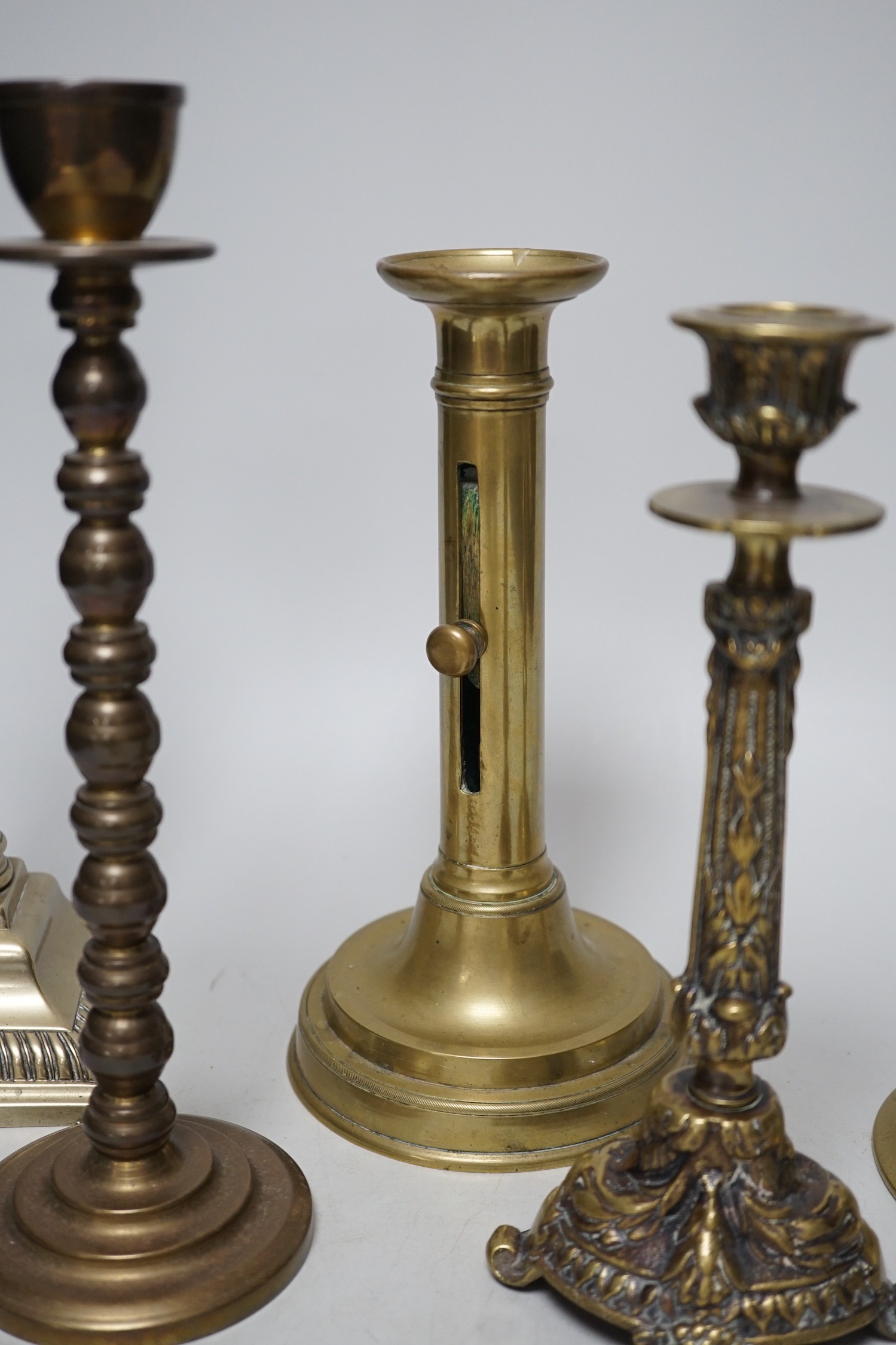 Five various brass candlesticks, tallest 26cms high